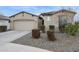 Beautiful exterior of a single-Gathering home with a two-car garage, desert landscaping, and neutral stucco siding at 5428 N 188Th Ln, Litchfield Park, AZ 85340