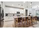 Stylish kitchen with white cabinets, a center island with bar seating, and modern stainless steel appliances at 5428 N 188Th Ln, Litchfield Park, AZ 85340