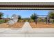 The community playground boasts a climbing wall, swings, benches, and a protective layer of wood chip ground cover at 5428 N 188Th Ln, Litchfield Park, AZ 85340