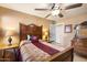 Cozy bedroom with a decorative bed frame, ceiling fan, and warm neutral tones at 5439 N Ormondo Way, Litchfield Park, AZ 85340