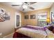 Comfortable bedroom with ceiling fan, neutral color palette, and ample natural light at 5439 N Ormondo Way, Litchfield Park, AZ 85340