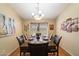 Formal dining room showcasing hardwood floors and decorative art under an elegant chandelier at 5439 N Ormondo Way, Litchfield Park, AZ 85340