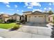 Inviting single-story house featuring desert landscaping, an attached two-car garage and gray stone accents at 5439 N Ormondo Way, Litchfield Park, AZ 85340