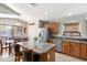 Bright kitchen featuring granite countertops, stainless steel appliances, and a large island with seating at 5439 N Ormondo Way, Litchfield Park, AZ 85340