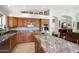 Well-lit kitchen with custom cabinets, granite countertops, tile floors, and stainless steel appliances at 5439 N Ormondo Way, Litchfield Park, AZ 85340