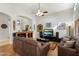 Comfortable living area boasts hardwood floors, a leather sofa, and a partial view into the kitchen at 5439 N Ormondo Way, Litchfield Park, AZ 85340