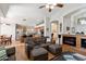 Inviting living space flows into the kitchen, featuring hardwood floors, a fireplace and leather seating at 5439 N Ormondo Way, Litchfield Park, AZ 85340