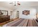 Bedroom featuring wood-look floors, a ceiling fan and a door to the backyard at 5439 N Ormondo Way, Litchfield Park, AZ 85340