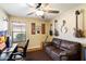 Home office featuring hardwood floors, ceiling fan, and a comfortable sitting area at 5439 N Ormondo Way, Litchfield Park, AZ 85340