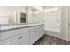 Bright bathroom features double sinks, granite countertop, and a shower over tub at 5462 W Fulton St, Phoenix, AZ 85043