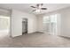 Carpeted bedroom features a ceiling fan, closet and a slider at 5462 W Fulton St, Phoenix, AZ 85043