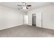 Carpeted bedroom features a ceiling fan, closet and a slider at 5462 W Fulton St, Phoenix, AZ 85043