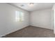 A bright bedroom with neutral carpeting and a window for natural light at 5462 W Fulton St, Phoenix, AZ 85043