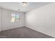 A bedroom featuring neutral carpeting, a window, and white walls at 5462 W Fulton St, Phoenix, AZ 85043