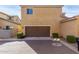 Exterior view of a home with a brown two-car garage and desert landscaping at 5462 W Fulton St, Phoenix, AZ 85043