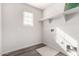 Well-lit laundry room with shelving and connections for appliances at 5462 W Fulton St, Phoenix, AZ 85043