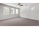 Living Room with neutral carpet, fan and multiple windows at 5462 W Fulton St, Phoenix, AZ 85043