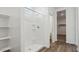 This bathroom features a tiled shower with built in shelves and a view into the walk-in closet at 5735 E Axle Ln, San Tan Valley, AZ 85140