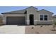 Charming single-story home featuring a two-car garage, neutral stucco, and well-maintained landscaping in a sunny setting at 5735 E Axle Ln, San Tan Valley, AZ 85140