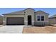 Charming single-story home with a gray exterior, a two-car garage, and a well-manicured lawn at 5735 E Axle Ln, San Tan Valley, AZ 85140