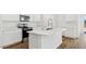 Close up of a kitchen island with stainless sink, range, and white countertops at 5735 E Axle Ln, San Tan Valley, AZ 85140