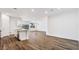 Open floor plan with kitchen island, stainless sink and modern wood-look tile flooring at 5735 E Axle Ln, San Tan Valley, AZ 85140