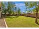 Backyard with a large grassy area and privacy wall that's perfect for relaxation and recreation at 6271 S Twilight Ct, Gilbert, AZ 85298