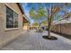 Paver patio with an outdoor kitchen area and lush tree that's perfect for entertaining guests at 6271 S Twilight Ct, Gilbert, AZ 85298