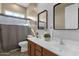 Well lit bathroom featuring a double sink vanity, modern mirrors, decorative accents and a shower/tub combo at 6271 S Twilight Ct, Gilbert, AZ 85298