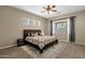 Comfortable bedroom featuring a ceiling fan, natural light, and neutral decor at 6271 S Twilight Ct, Gilbert, AZ 85298