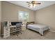 Neutral bedroom with a ceiling fan, carpet flooring, and a desk area for working or studying at 6271 S Twilight Ct, Gilbert, AZ 85298