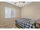 Bright bedroom with natural light, a ceiling fan, and neutral decor at 6271 S Twilight Ct, Gilbert, AZ 85298