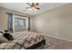 Cozy bedroom boasts a ceiling fan, window, and neutral walls at 6271 S Twilight Ct, Gilbert, AZ 85298