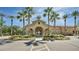 Elegant community center entrance lined with palm trees and manicured landscaping at 6271 S Twilight Ct, Gilbert, AZ 85298