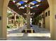 Inviting courtyard with bench, tiled floor, palm tree in the center, and pergola at 6271 S Twilight Ct, Gilbert, AZ 85298