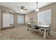 Dining room featuring neutral walls, plantation shutters, ceiling fan, and access to other living areas at 6271 S Twilight Ct, Gilbert, AZ 85298