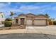 Beautiful single-story home with stone accents, three-car garage, desert landscaping, and an American flag displayed at 6271 S Twilight Ct, Gilbert, AZ 85298