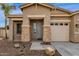 Inviting front entrance with stone pillars and covered porch, offering a glimpse of the American flag at 6271 S Twilight Ct, Gilbert, AZ 85298