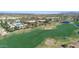 An aerial view of the golf course with a swimming pool, lake, and other community amenities at 6271 S Twilight Ct, Gilbert, AZ 85298