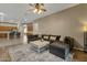 Relaxing living room featuring a sectional sofa and view of the open concept kitchen and dining areas at 6271 S Twilight Ct, Gilbert, AZ 85298