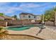 Backyard pool with basketball hoop, patio, and view of the two-story house at 6271 S Twilight Ct, Gilbert, AZ 85298