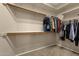 A simple, yet functional, walk-in closet with shelving and hanging rods at 6271 S Twilight Ct, Gilbert, AZ 85298