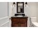 Well-lit bathroom featuring a dark wood vanity with granite countertop, a stylish mirror, and sconce lighting at 7175 E Camelback Rd # 1106, Scottsdale, AZ 85251