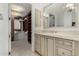 Elegant bathroom featuring a vanity with a large mirror, cabinets, and a glimpse into a spacious walk-in closet at 7175 E Camelback Rd # 1106, Scottsdale, AZ 85251