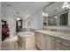 Luxurious bathroom featuring dual vanities, a soaking tub, and elegant lighting fixtures at 7175 E Camelback Rd # 1106, Scottsdale, AZ 85251