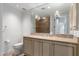 Bathroom with a vanity, a large mirror, and neutral tiled walls around the shower at 7175 E Camelback Rd # 1106, Scottsdale, AZ 85251