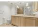 Bright bathroom with a vanity, a large mirror, and neutral tiled walls around the shower at 7175 E Camelback Rd # 1106, Scottsdale, AZ 85251