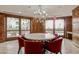 Elegant dining area features a round table, red leather chairs, chandelier, and access to a patio at 7175 E Camelback Rd # 1106, Scottsdale, AZ 85251