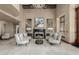 Grand living room featuring an ornate fireplace, marble floors, comfortable seating, and a decorative chandelier at 7175 E Camelback Rd # 1106, Scottsdale, AZ 85251