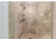 Tiled shower featuring multiple shower heads and a built in shelf at 7175 E Camelback Rd # 1106, Scottsdale, AZ 85251